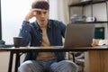 Stressed Arabic Man Using Laptop Sitting At Desk In Office