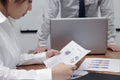 Stressed Asian business woman analyzing charts or paperwork during meeting in conference room. Royalty Free Stock Photo