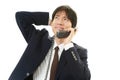 Stressed Asian businessman Royalty Free Stock Photo