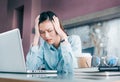 Stressed Asian businesswoman cover her face with hand and feel d