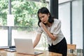 Stressed Asian businesswoman or female employee having a serious phone call with her business client while working in Royalty Free Stock Photo