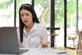 Stressed Asian businesswoman having a problems on her work while using laptop Royalty Free Stock Photo