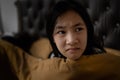 Stressed asian child girl suffering nightmare,waking up at night on her bed in the dark bedroom,flinch,shudder,startled from a Royalty Free Stock Photo