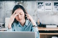 Stressed Asian creative designer woman cover her face with hand