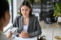 Stressed Asian female lawyer refusing money or bribe from her client