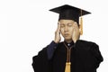 Stressed of Asian Graduate man in cap and gown have a headache Royalty Free Stock Photo