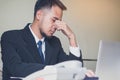 Stressed Asian male employee sitting in the office tired after overwork all night