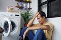 stressed asian Man doing laundry at home Royalty Free Stock Photo