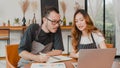 Stressed Asian small business owners couple using laptop discussing project and finance with documents of shop for the month at Royalty Free Stock Photo