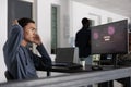 Stressed asian web developer having security breach alert on computer screen Royalty Free Stock Photo