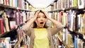 Stressed asian woman holding to head at library Royalty Free Stock Photo