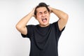 Stressed asian young young man holding head