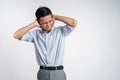 Stressed asian young young man holding head