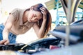 Stressed beautiful Asian woman car broken down on the side of the road