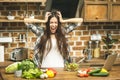 Stressed beautiful young woman in kitchen. Tired at home. Crying woman