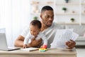 Stressed Black Father With Little Baby Trying To Work At Home Office Royalty Free Stock Photo