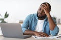 Stressed Black Male Entrepreneur Having Problems At Work, Sitting Upset In Office