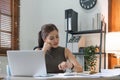 Stressed and bored young woman checking bills, taxes, bank account balance and calculating expenses in the living room Royalty Free Stock Photo