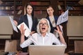 Stressed boss and her female colleagues posing in office Royalty Free Stock Photo