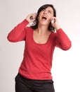 Stressed brunette talking with two phones