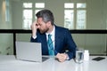 Stressed business man having headache at office. Tired businessman is working overtime and has headache. Overworked man Royalty Free Stock Photo