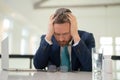 Stressed business man having headache at office. Tired businessman is working overtime and has headache. Overworked man Royalty Free Stock Photo