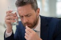 Stressed business man having headache at office. Tired businessman is working overtime and has headache. Man taking a Royalty Free Stock Photo