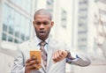 Stressed business man looking at wrist watch, running late for meeting outside corporate office Royalty Free Stock Photo