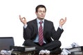 Stressed business man meditates at desk in office Royalty Free Stock Photo