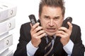 Stressed business man with telephones is crying Royalty Free Stock Photo