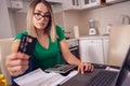Stressed business woman at home working - paying bills e banking