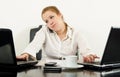 Stressed business woman multitasking in her office Royalty Free Stock Photo