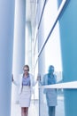 Stressed business woman standing next to the wall of an office building Royalty Free Stock Photo