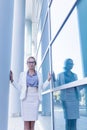 Stressed business woman standing next to the wall of an office building Royalty Free Stock Photo