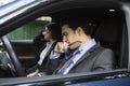 Stressed businessman driving and his female colleague in suit and standing in a traffic jam Royalty Free Stock Photo