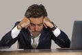 Stressed businessman feeling depressed and overwhelmed working at office computer desk tired and exhausted defeated by business f Royalty Free Stock Photo