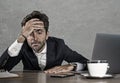 Stressed businessman feeling depressed and overwhelmed working at office computer desk tired and exhausted defeated by business f Royalty Free Stock Photo