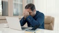 Stressed businessman feeling sick and tired while sitting at his working place Royalty Free Stock Photo