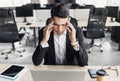 Stressed businessman having problems at work. Tired men having headache during the hard working day in the office Royalty Free Stock Photo