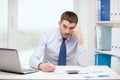 Stressed businessman with laptop and documents Royalty Free Stock Photo