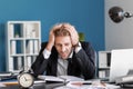 Stressed businessman missing deadlines in office