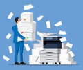 Stressed businessman with pile of office documents