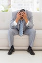 Stressed businessman sitting on couch Royalty Free Stock Photo