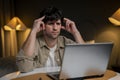 Stressed businessman is sitting at his workplace. A tired and overworked male student. Young exhausted men in a state of Royalty Free Stock Photo