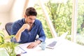 Stressed businessman sitting at office desk and using laptop for work Royalty Free Stock Photo