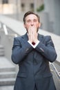 Stressed businessman standing outdoors with his hands covering his face Royalty Free Stock Photo