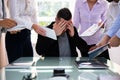 Stressed Businessman Surrounded By His Colleagues Royalty Free Stock Photo