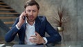 Stressed businessman talking on phone emotionally. Focused man calling phone. Royalty Free Stock Photo