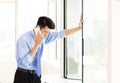 Stressed businessman talking on the phone in office