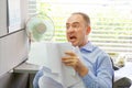 Businessman at his desk throws documents and papers into the air Royalty Free Stock Photo